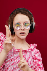 woman in a pink jacket with headphones glasses in the form of a diamond