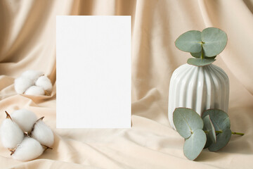 Boho invitation mockup with cotton and eucalyptus leaves