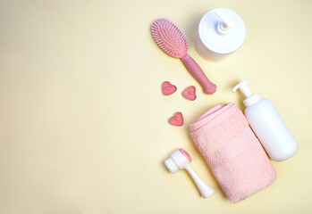 Women's bath accessories and cosmetic procedures, pink towel on a beige background. Pink tones. Copy space. Flat lay.