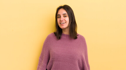 young hispanic woman with a big, friendly, carefree smile, looking positive, relaxed and happy,...