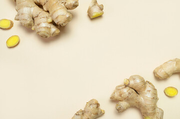 Fresh ginger root chopped ginger pieces on beige background top view flat lay. Spice for cooking,...