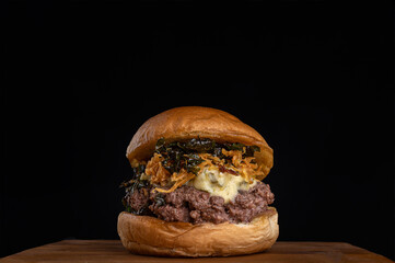 Homemade burger with onion and kale crispy with melted mozzarella cheese