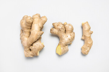Fresh ginger root on light gray background top view flat lay. Spice for cooking, herbal tea with...