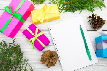 Blank open notepad, pine branches and Christmas decorations on a white wooden table. Space for text. Top view. Flat lay style...- Image