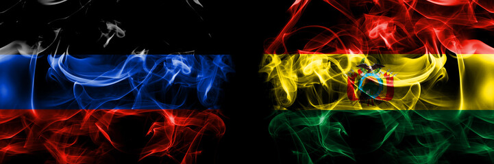 Donetsk People's Republic vs Bolivia, Bolivian flag. Smoke flags placed side by side isolated on black background.