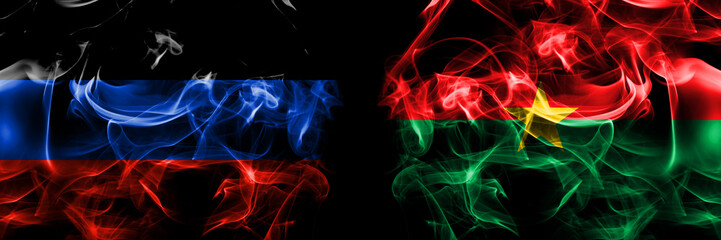 Donetsk People's Republic vs Burkina Faso, Burkinese flag. Smoke flags placed side by side isolated on black background.