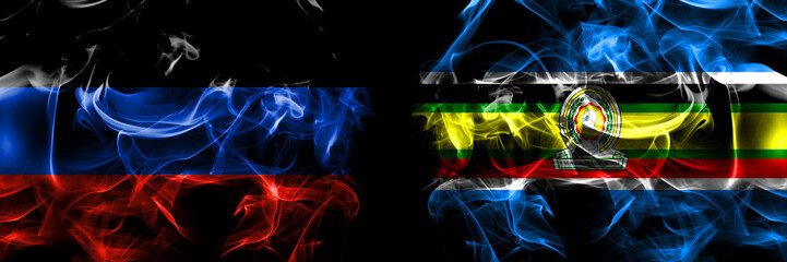 Donetsk People's Republic vs East African Community, Africa flag. Smoke flags placed side by side isolated on black background.