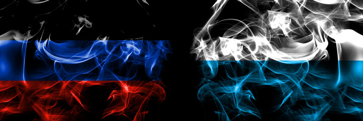 Donetsk People's Republic vs Germany, Bavaria flag. Smoke flags placed side by side isolated on black background.