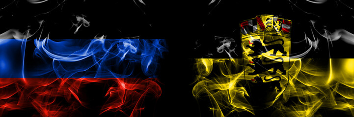 Donetsk People's Republic vs Germany, German, Deutschland, Baden Wurttemberg flag. Smoke flags placed side by side isolated on black background.
