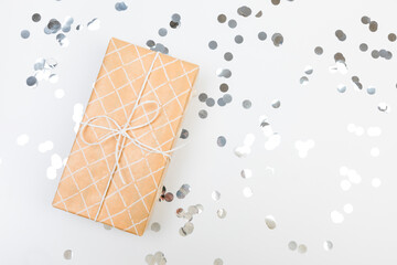 gifts or presents boxes silver confetti on white table top view. Flat lay composition for birthday, christmas or wedding. - Image