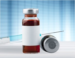 Small vaccine bottle for Coronavirus Vaccine injection with a medical syringe.
