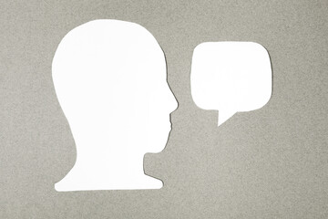  paper face and speech bubble on colorbackground copy space for text, communication, symbolic- Image