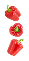 Peppers, sweet red bulgarian, three falling, hanging, flying, soaring, isolated on white background, full depth of field.