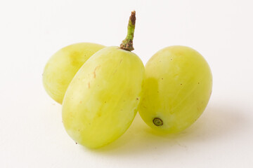 green grapes on white table, white background