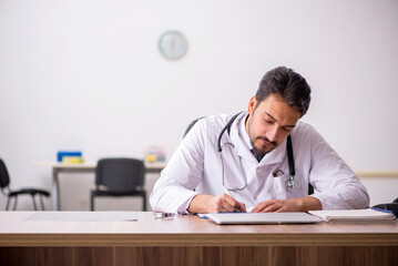 Young male doctor working in the clinic