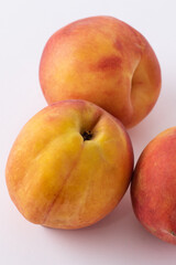 fresh peaches on a white meza