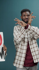 Group of young activists protest against discrimination with stop racism poster