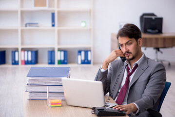 Young male employee working in the office