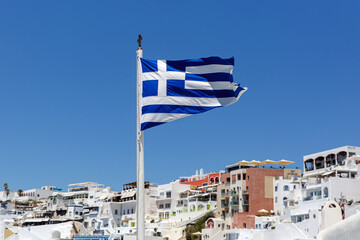 Greek flag waving against the blue sky and Greek architecture © 9parusnikov