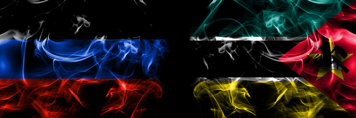 Donetsk People's Republic vs Mozambique, Mozambican flag. Smoke flags placed side by side isolated on black background.