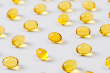 Close up of  oil filled capsules suitable for: fish oil, omega 3, omega 6, omega 9,  vitamin A, vitamin D, vitamin D3, vitamin E - Image