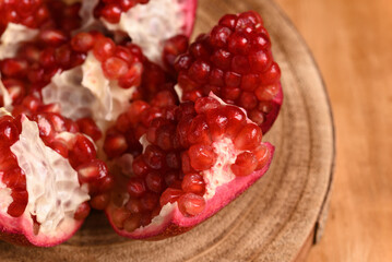 Sliced ​​pomegranates on the wooden board.
