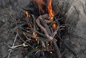 Blurred image of a campfire from branches in nature.The concept of outdoor recreation.