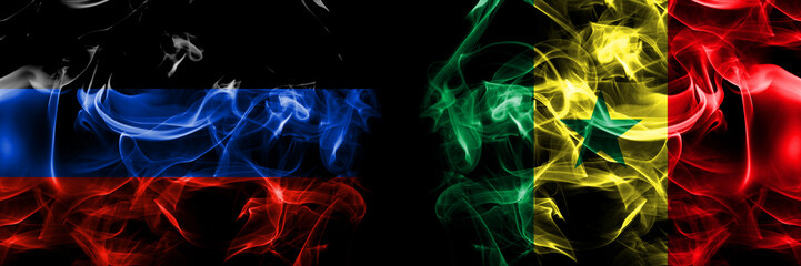 Donetsk People's Republic vs Senegal flag. Smoke flags placed side by side isolated on black background.