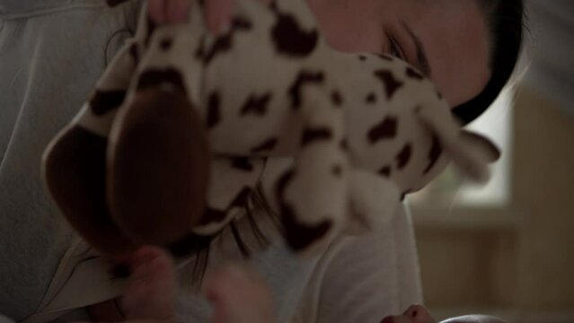 Newborn Baby With Young Mom look Into Each Other Eye. Cute Smiling Teethless Kid Face Portrait. Woman Kissing With Child Look At Camera. Infant, Mother Day, Childbirth, Beginning, Relationship Concept