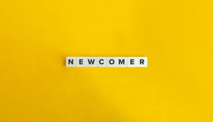 Newcomer Word on Letter Tiles on Yellow Background. Minimal Aesthetics.