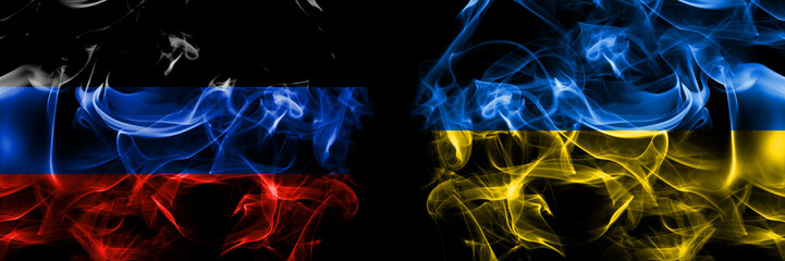 Donetsk People's Republic vs Ukraine, Ukrainian flag. Smoke flags placed side by side isolated on black background.