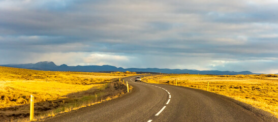 Fototapeta na wymiar Iceland road landscape with clouds and emply field