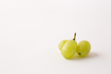 green grapes on white table, white background