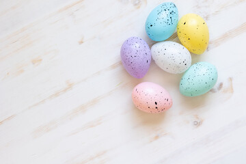 Obraz na płótnie Canvas Easter eggs on a white wood background with copy space