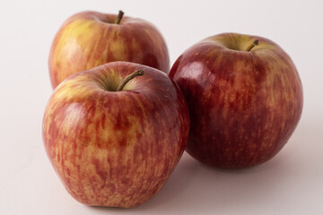 fresh red apples on a white table