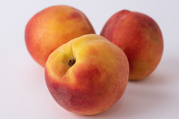 fresh peaches on a white meza