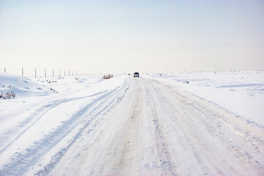 Car Driving On A Snowy Road, Aksu Prefecture, Xinjiang, China