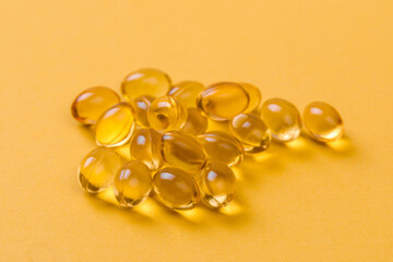 Close up of  oil filled capsules suitable for: fish oil, omega 3, omega 6, omega 9,  vitamin A, vitamin D, vitamin D3, vitamin E - Image
