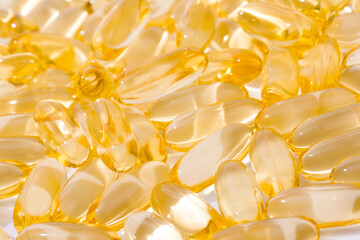 Close up of  oil filled capsules suitable for: fish oil, omega 3, omega 6, omega 9,  vitamin A, vitamin D, vitamin D3, vitamin E - Image