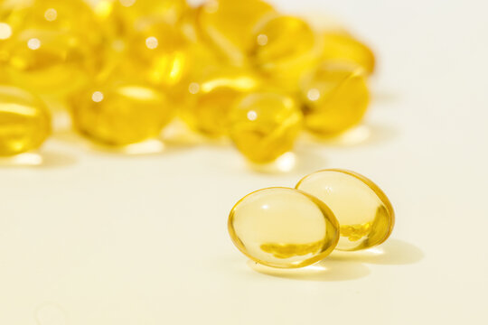 Close up of  oil filled capsules suitable for: fish oil, omega 3, omega 6, omega 9,  vitamin A, vitamin D, vitamin D3, vitamin E - Image