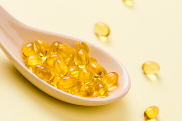 Close up of  oil filled capsules on spoon suitable for: fish oil, omega 3, omega 6, omega 9,  vitamin A, vitamin D, vitamin D3, vitamin E - Image