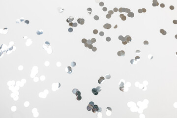 round silver confetti on white background flat lay text place .