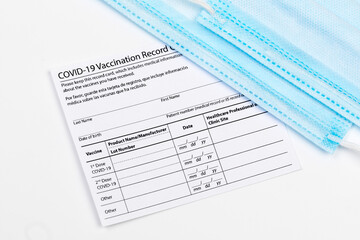 Coronavirus vaccination record card. Protective mask divided into two parts. Concept of defeating Covid-19 - Image