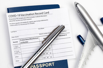 COVID-19 vaccination record card and tourist passport of traveler for worldwide travel during coronavirus pandemic. - Image