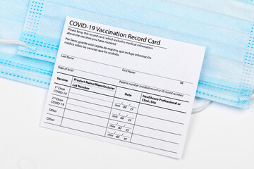 Coronavirus vaccination record card. Protective mask divided into two parts. Concept of defeating Covid-19 - Image