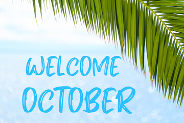 Fototapeta na wymiar Welcome October text on the background with palm leaf and blue sea. Template of a greeting card, postcard or advertisement of a tour agency. 