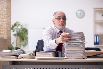 Aged male employee and too much work at workplace