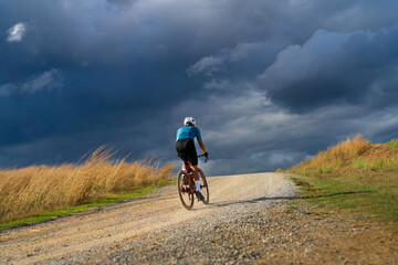 Cyclists practicing on gravel roads  in bad weather day
