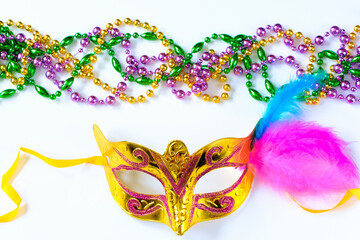Carnival mask with feathers and colorful beads on white background. Mardi Gras or Fat Tuesday symbol.