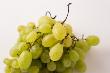 green grapes on white table, white background